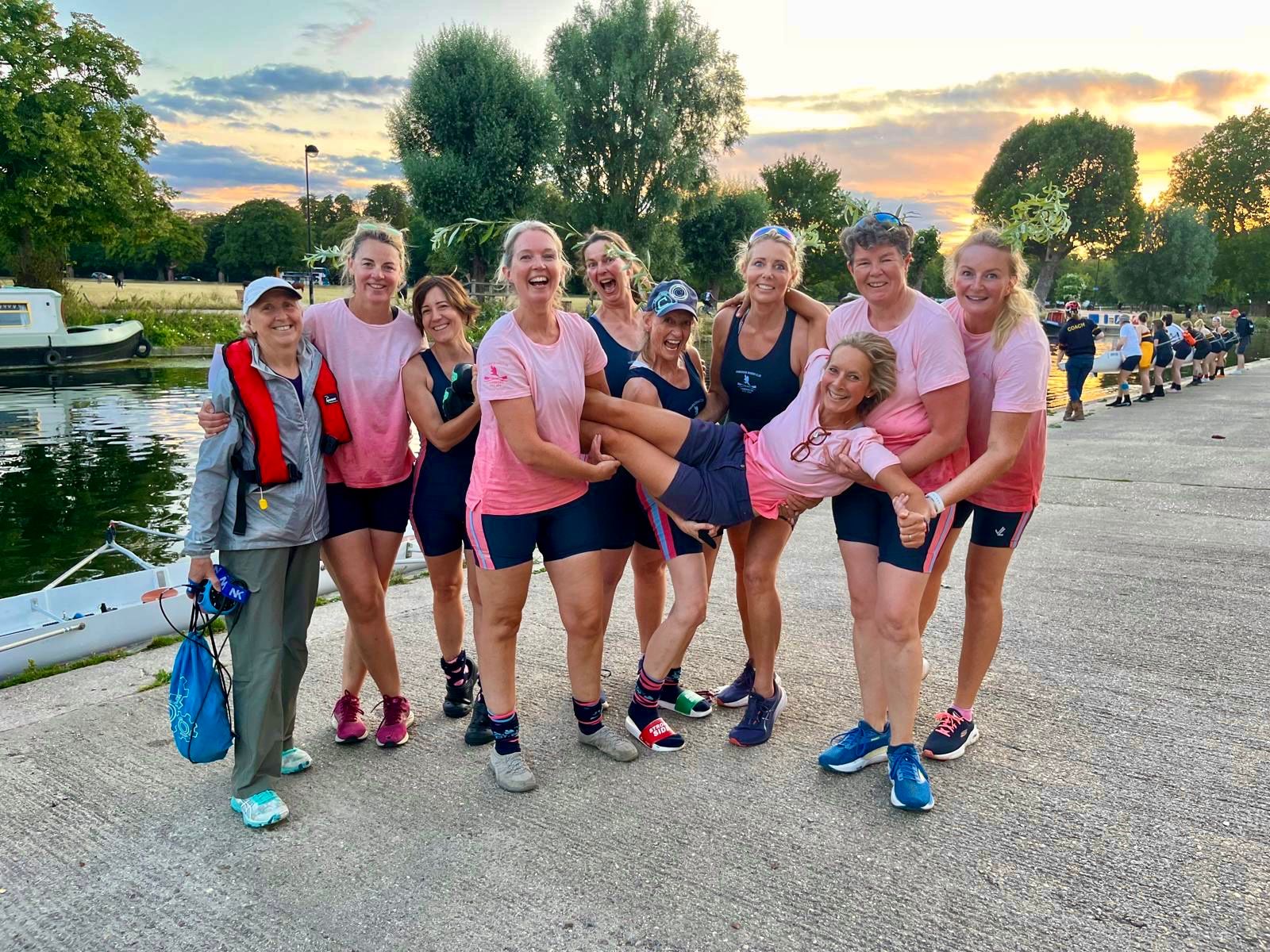 Peregrine Rowing Club team celebrating at sunset by the River Cam